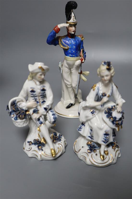 A Naples style figure of a soldier, a pair of Sitzendorf figures and a German centrepiece